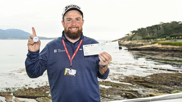 Shane Lowry holds his scorecard and the Srixon ball he used for his hole-in-one on the seventh hole after the first round of the AT&T Pebble Beach Pro-Am in Pebble Beach, California.