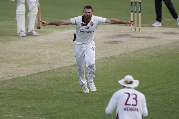 Michael Neser of Queensland celebrates the wicket of Jack Edwards of New South Wales.