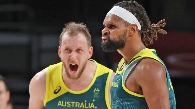 Patty Mills #5 and Joe Ingles #7 of Team Australia react against Team Slovenia