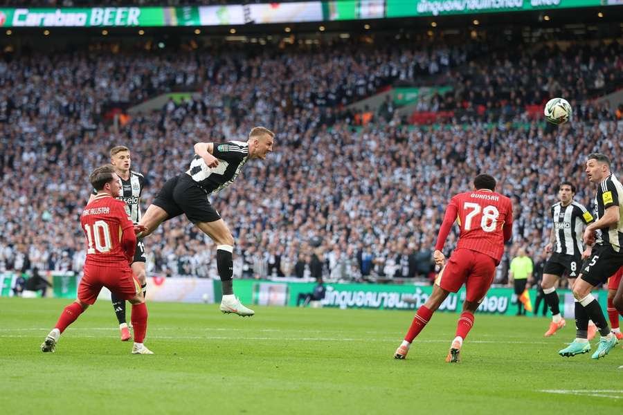 Newcastle's Dan Burn scores the first goal of the Carabao Cup final against Liverpool Newcastle's Dan Burn scores the first goal of the Carabao Cup final against Liverpool