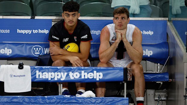 Hugo Garcia (tactical) and Mason Wood (concussion) on the Saints' bench after being substituted against the Lions.