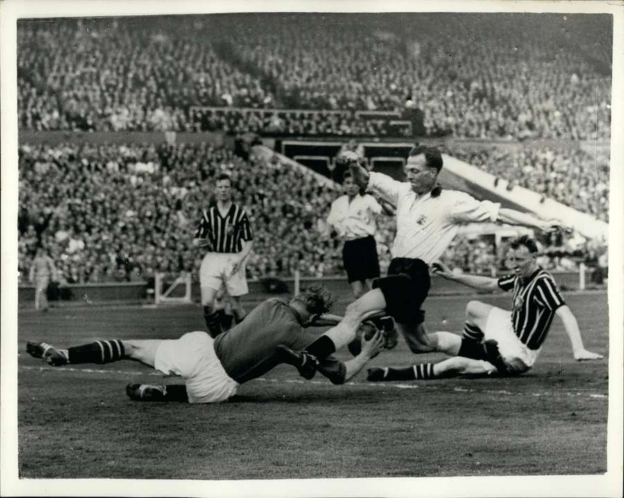 Bert Trautmann of Manchester City dives to save the ball from Birmingham City’s Peter Murphy during the 1956 FA Cup final at Wembley Bert Trautmann of Manchester City dives to save the ball from Birmingham City’s Peter Murphy during the 1956 FA Cup final at Wembley