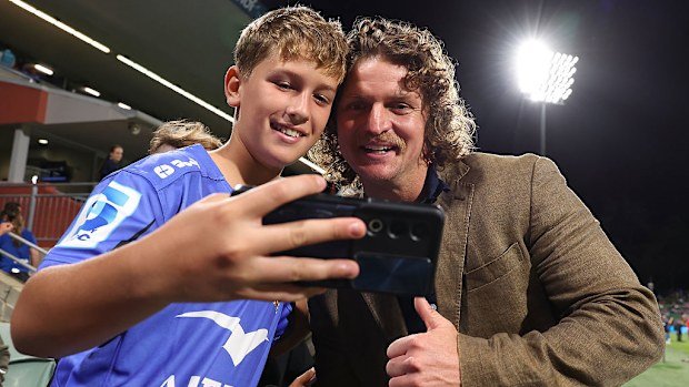 Nick Cummins shares selfies with young fans.