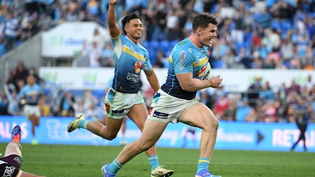 Beau Fermor of the Titans makes a break to score a try.