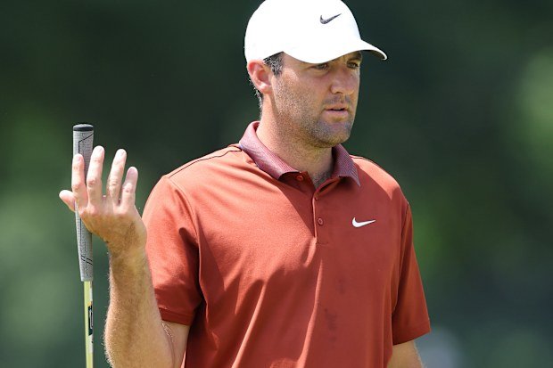 Scottie Scheffler of the United States reacts to a putt on the second hole.