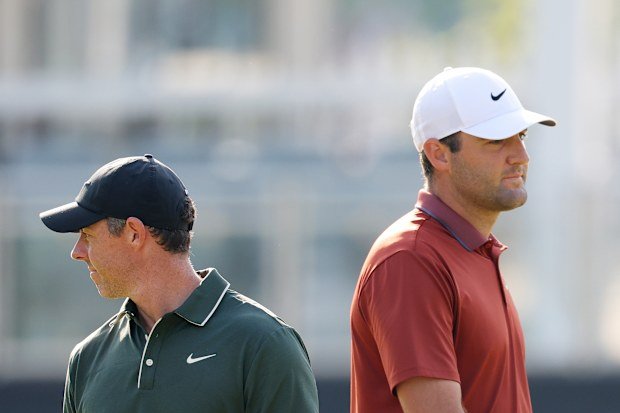 Scottie Scheffler of the United States and Rory McIlroy of Northern Ireland look on while playing the 10th hole during the first round of the PGA Championship at Quail Hollow Country Club.