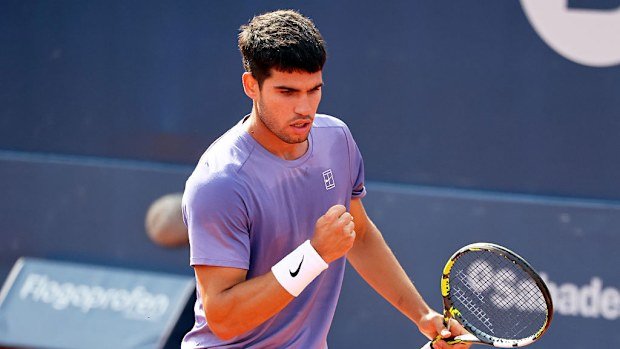 Carlos Alcaraz in action during a match against Alex de Minaur.