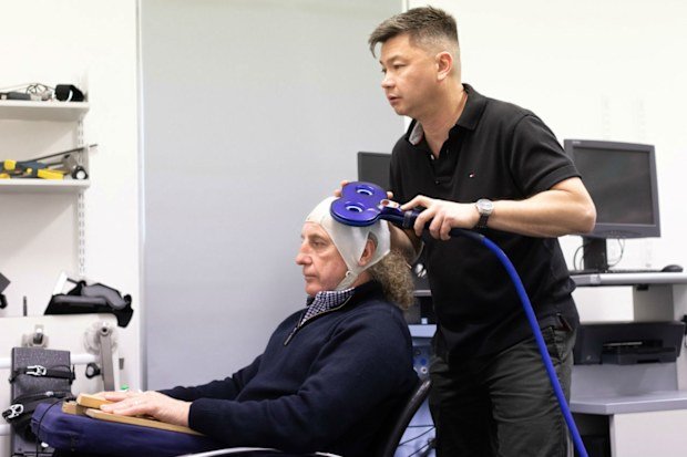 Dr Alan Pearce carrying out testing on Hawthorn great John Platten, who's now suffering the effects of repeated concussions from his footy days. The picture is being used with Platten's permission.