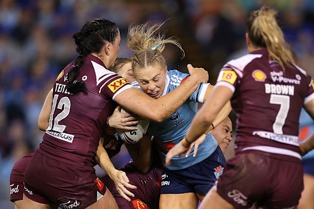 Abbi Church of the NSW Blues being tackled.
