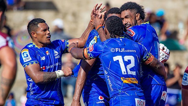 Drua players celebrate a try.