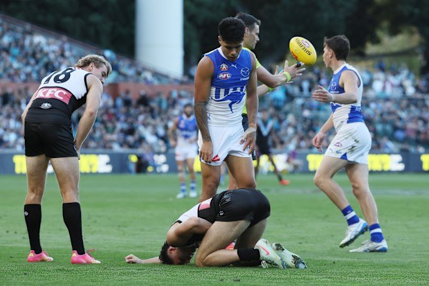 Josh Sinn remains down after being tackled by Paul Curtis.