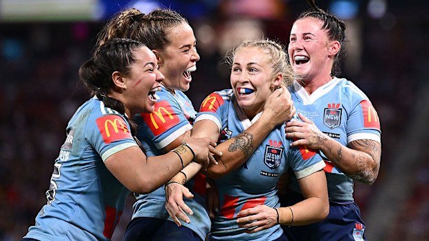 Players of the Blues celebrate defeating the Maroons in game one of the 2025 Women's State of Origin series.