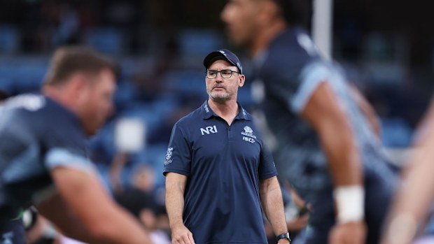 Waratahs coach Dan McKellar observes warm-up.