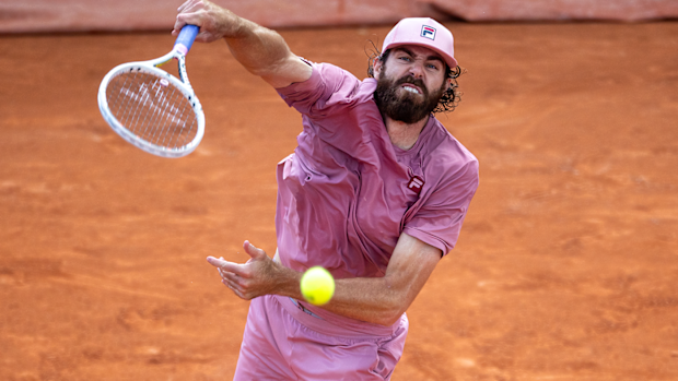 Reilly Opelka serves against Rinky Hijikata in their first-round match at Roland-Garros.