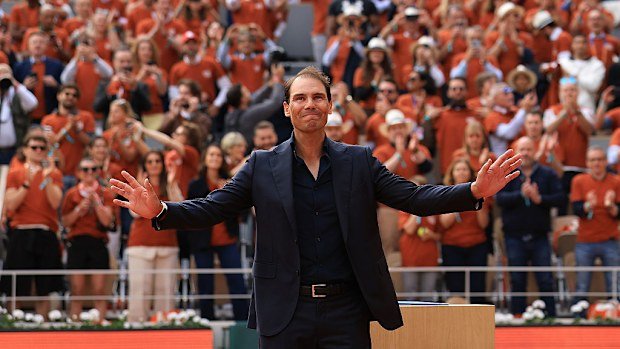 Rafael Nadal greets the crowd as he walks out on Court Philippe-Chatrier for a ceremony.