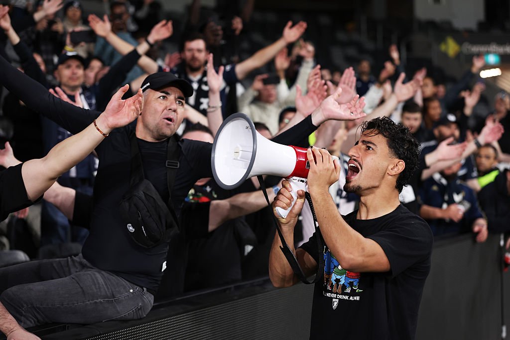 Arzani celebrates with fans after a match