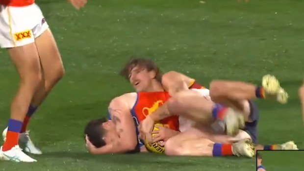 Lachie Neale reaching for his head after the incident.