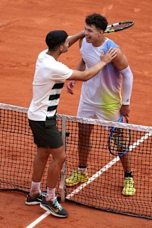 Carlos Alcaraz and Ben Shelton embrace at the net after their match.