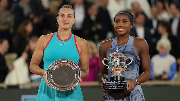 Coco Gauff holds the Coupe Suzanne Lenglen trophy alongside runner-up Aryna Sabalenka.