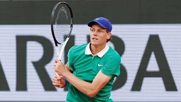 Jannik Sinner of Italy plays a backhand against Novak Djokovic of Serbia.
