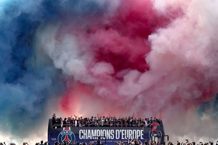 PSG celebrate with the Champions League trophy on the Champs-Elysees PSG celebrate with the Champions League trophy on the Champs-Elysees