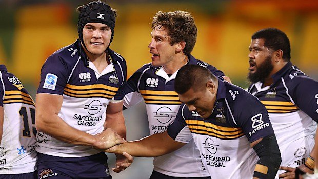 The Brumbies players celebrate after winning.