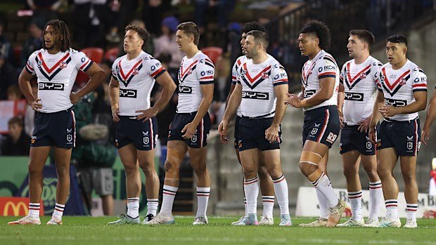 Roosters players react to a Knights try.