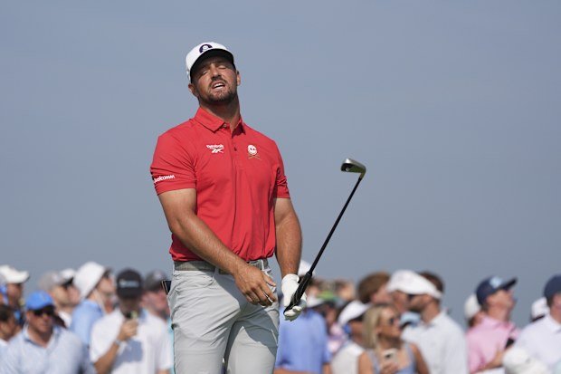 Bryson DeChambeau reacts to his tee shot on the sixth hole.