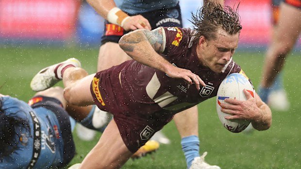 Cameron Munster scores a try in his first game as captain of the Maroons.