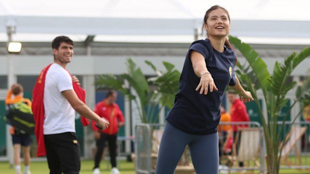 Carlos Alcaraz of Spain and Emma Raducanu of Great Britain in warm-up.