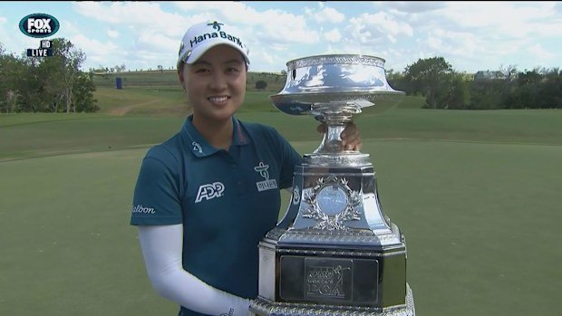 Minjee Lee proudly holding her PGA Championship trophy.