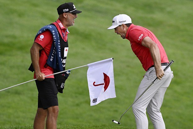 Keegan Bradley celebrates with caddie Scott Vail after winning the Travelers Championship.