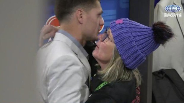 Kalyn Ponga shares a hug with his mum after suffering a foot injury.