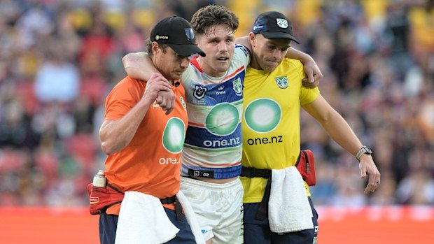 Luke Metcalf of the Warriors is helped from the field after suffering a leg injury.