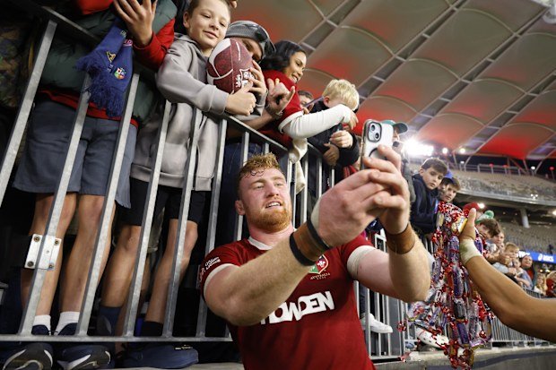 Ollie Chessum of the British and Irish Lions takes a selfie with fans in Perth.
