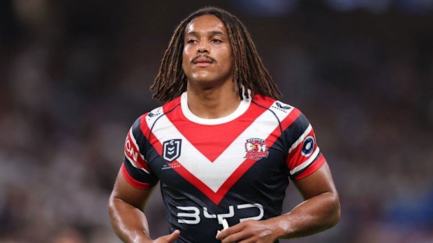 Dominic Young of the Roosters looks on.