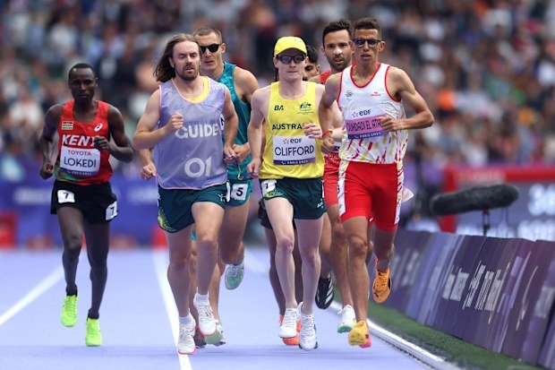 Jaryd Clifford and guide runner Tim Logan, who assisted him over the first half of the T13 5000m final at Paris 2024, competing against Yassine Ouhdadi El Ataby.