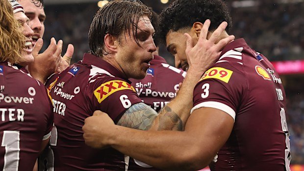 Cameron Munster, the newly appointed Maroons captain, celebrates with Robert Toia after Hamiso Tabuai-Fidow scores.