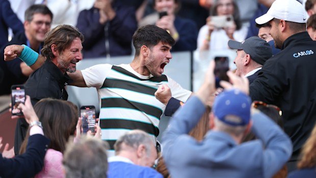 Carlos Alcaraz of Spain celebrates with his team and family following his victory over Jannik Sinner.