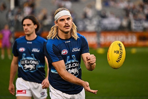 Bailey Smith of the Cats warms up.