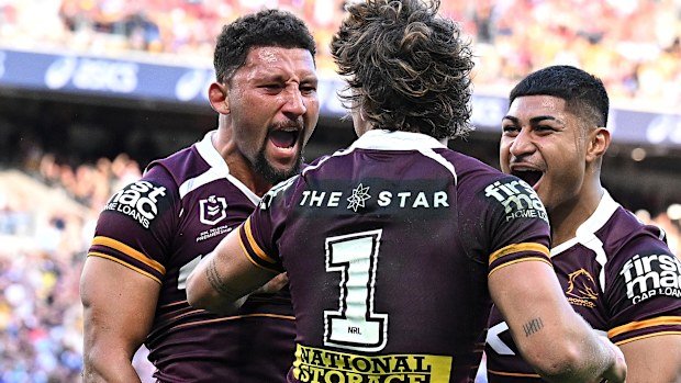Gehamat Shibasaki of the Broncos celebrates with teammates after scoring a try.