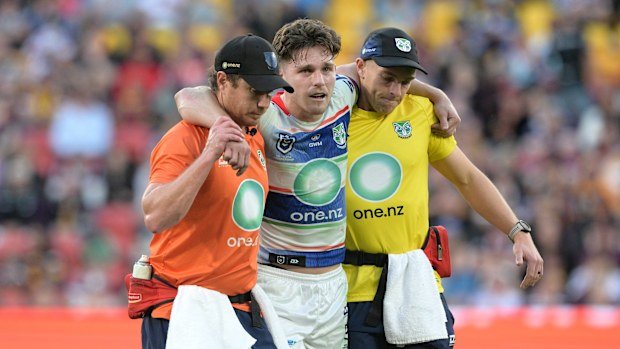 Luke Metcalf of the Warriors is helped from the field after suffering a leg injury.