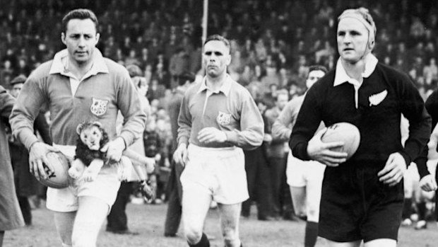 British Lions captain Ronnie Dawson carries a mascot before playing the All Blacks in 1959.