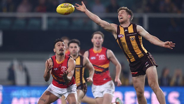 Dylan Moore of the Hawks spoils it from Izak Rankine.