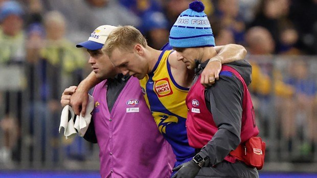 Oscar Allen being carried from the pitch.
