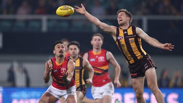 Dylan Moore of the Hawks spoils it from Izak Rankine.