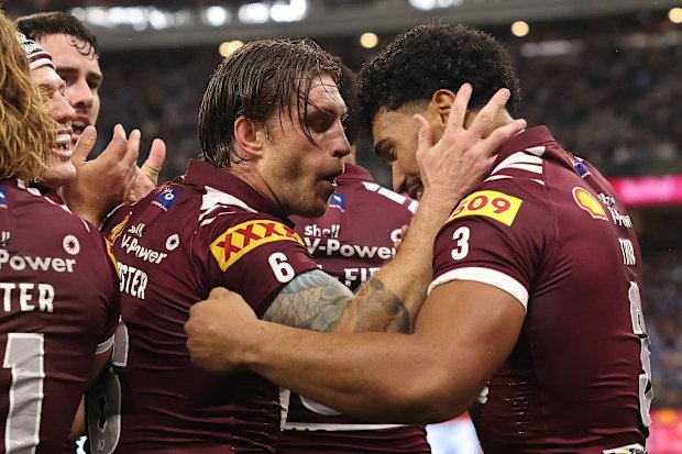Newly appointed Maroons captain Cameron Munster celebrates with Robert Toia after Hamiso Tabuai-Fidow scored a try.