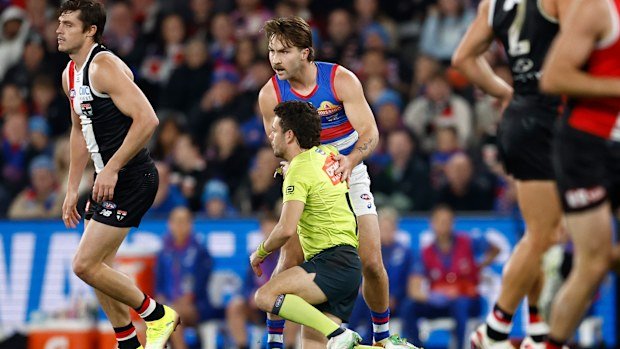 MELBOURNE, AUSTRALIA - JUNE 12: Curtis Deboy, AFL Field Umpire and Rhylee West of the Bulldogs come into contact during the 2025 AFL Round 14 match between the St Kilda Saints and the Western Bulldogs at Marvel Stadium on June 12, 2025 in Melbourne, Australia. (Photo by Michael Willson/AFL Photos via Getty Images)