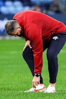 British & Irish Lions head coach Andy Farrell checks the pitch.