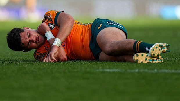 Noah Lolesio of the Wallabies lies injured.